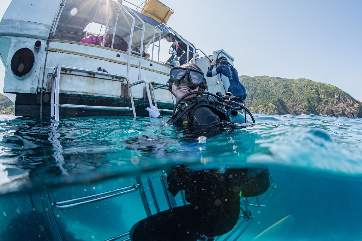 A guest climbing back onto the boat, captured in a half-and-half shot.
