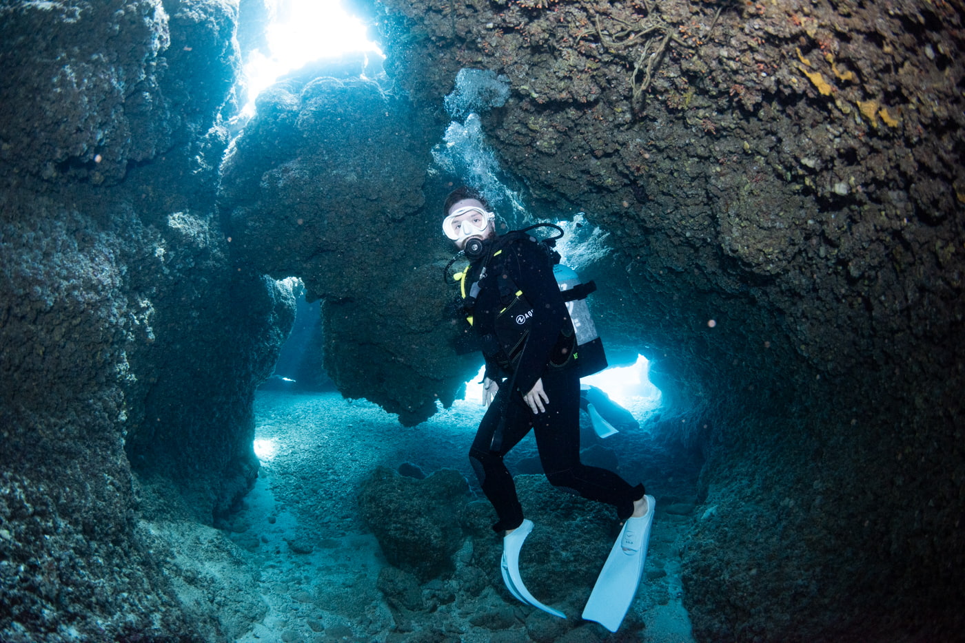 Guests diving inside a cave in the Kerama Islands.