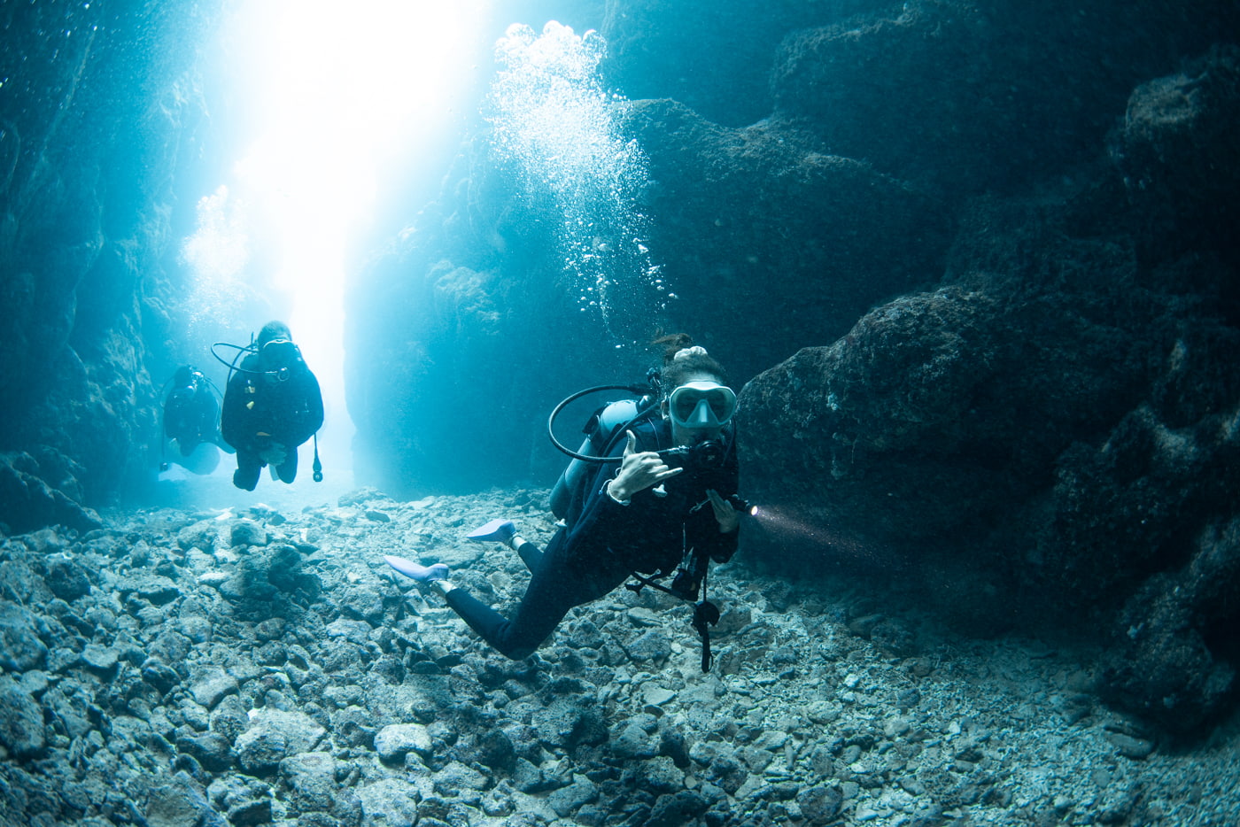Guests diving inside a cave.