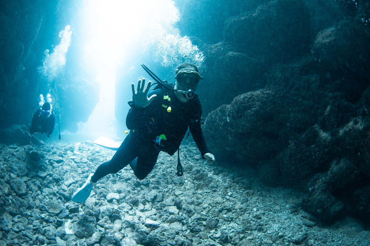 Guests diving inside a cave.
