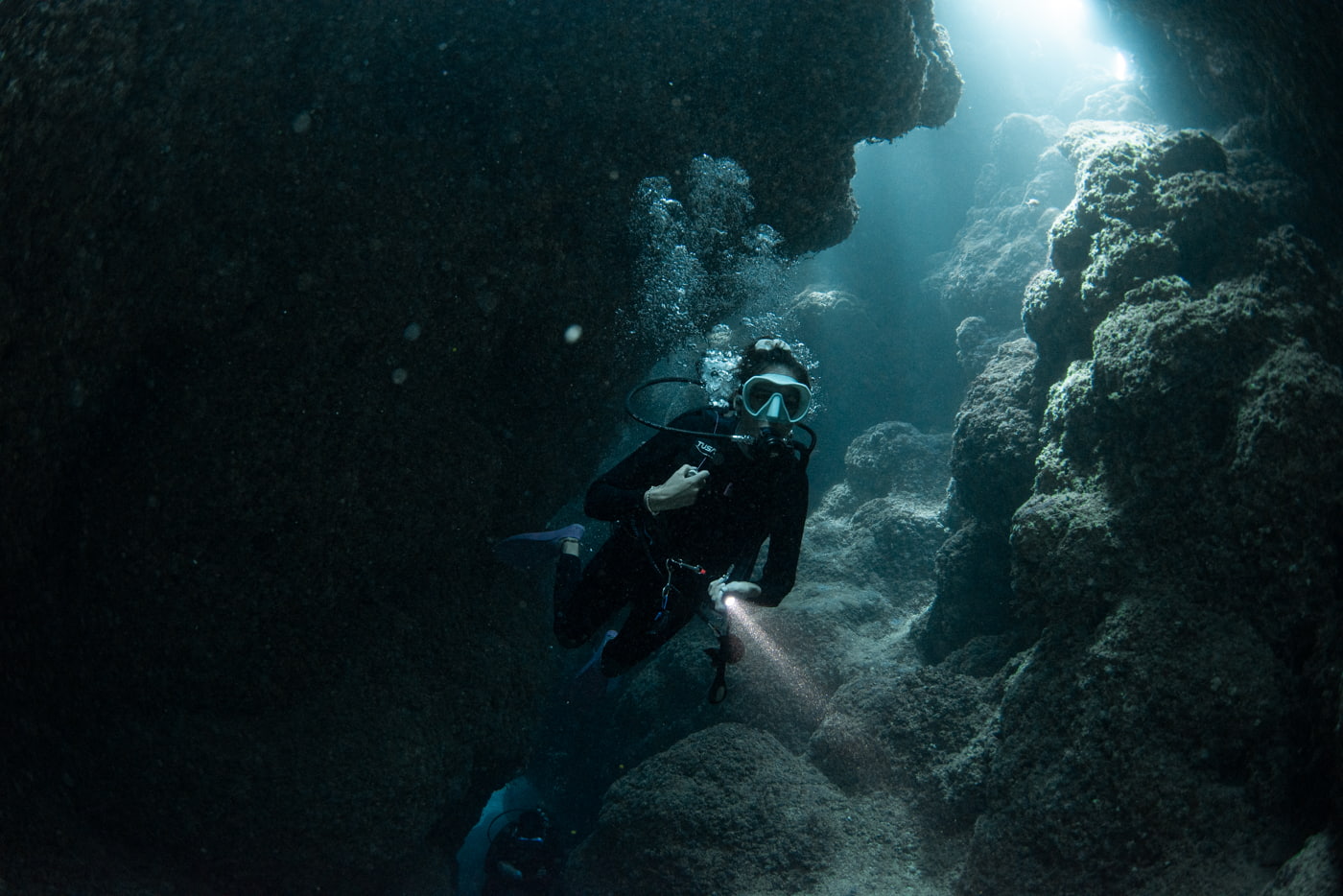 Guests diving inside a cave.