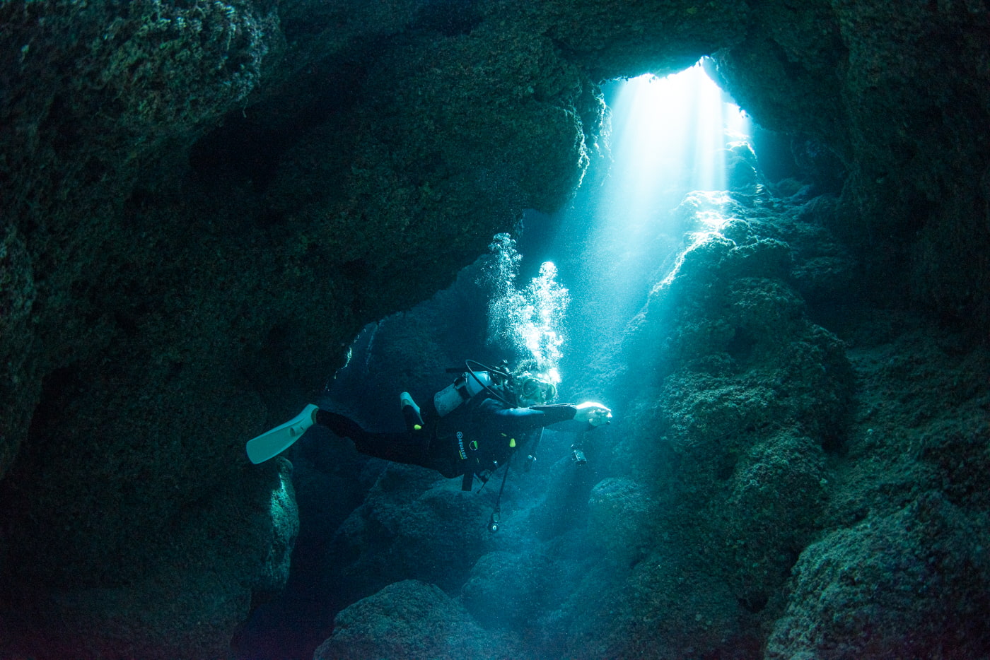 Guests diving inside a cave.