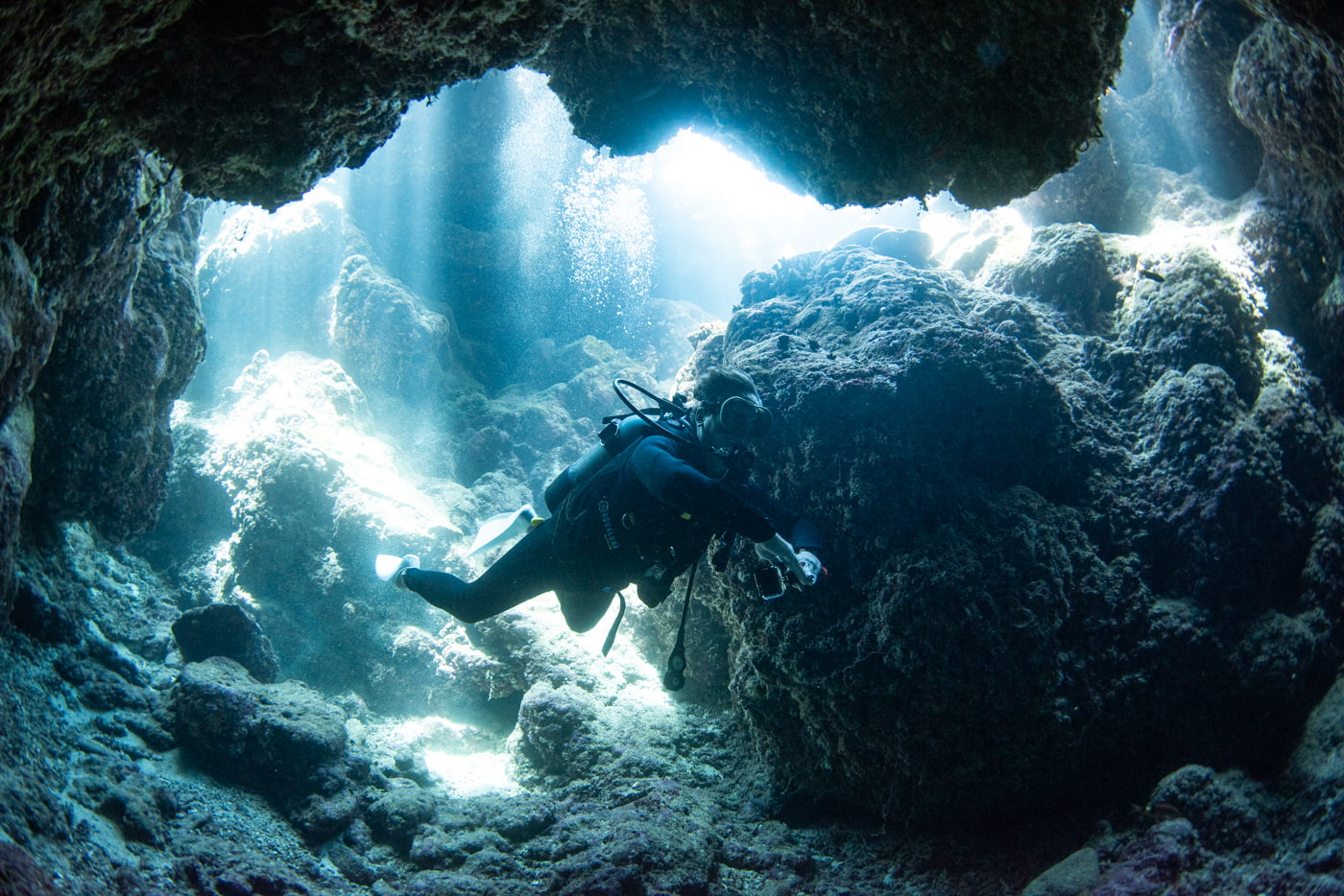 Guests diving inside a cave.