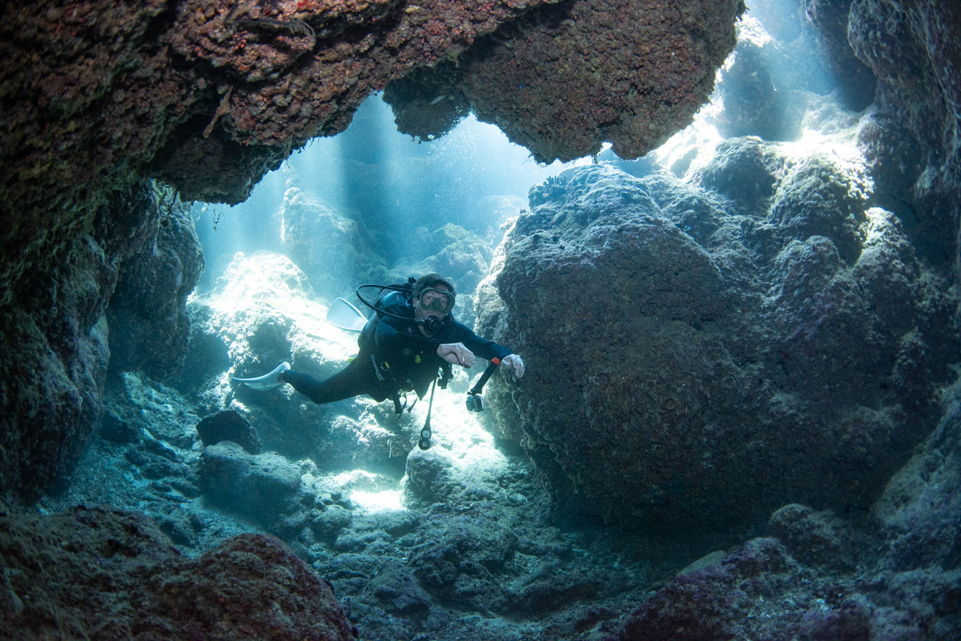 Guests diving inside a cave.