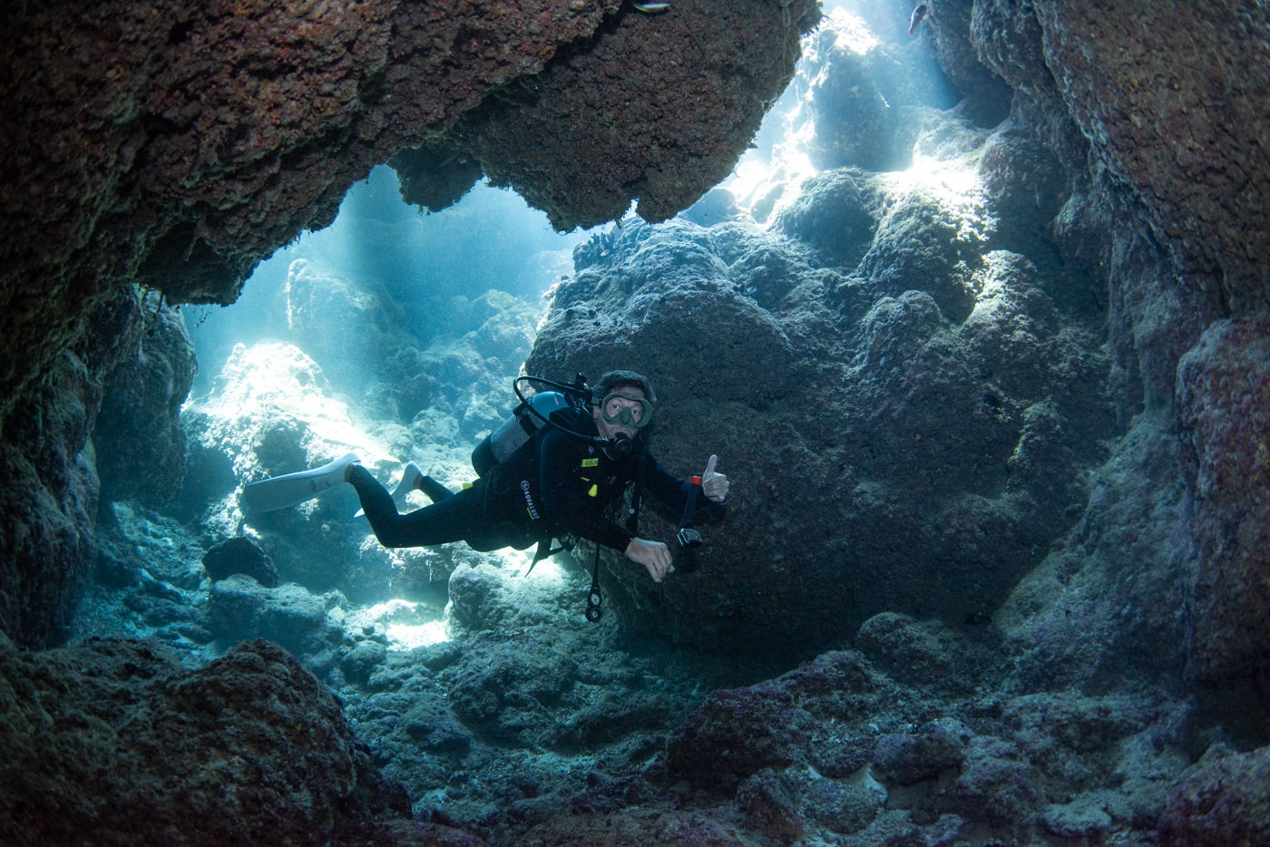 Guests diving inside a cave.
