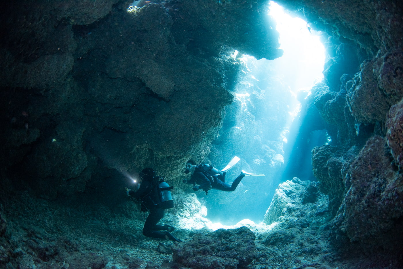 Guests diving inside a cave.