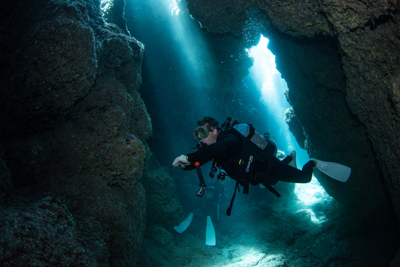 Guests diving inside a cave.