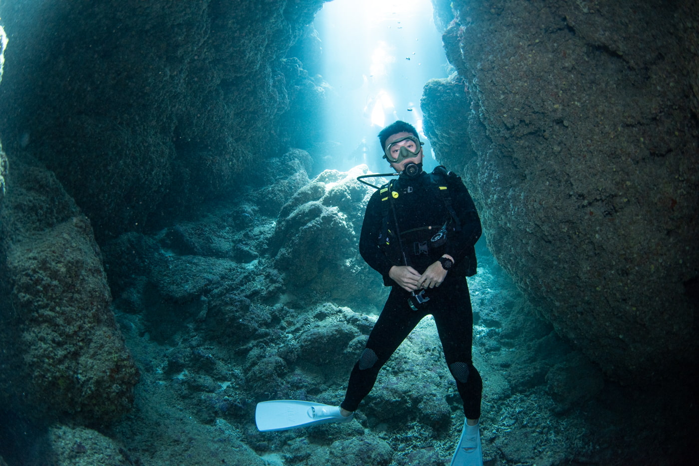 Guests diving inside a cave.