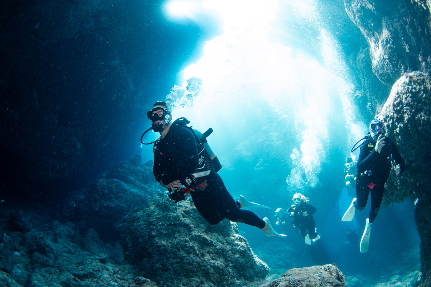 Guests diving inside a cave.
