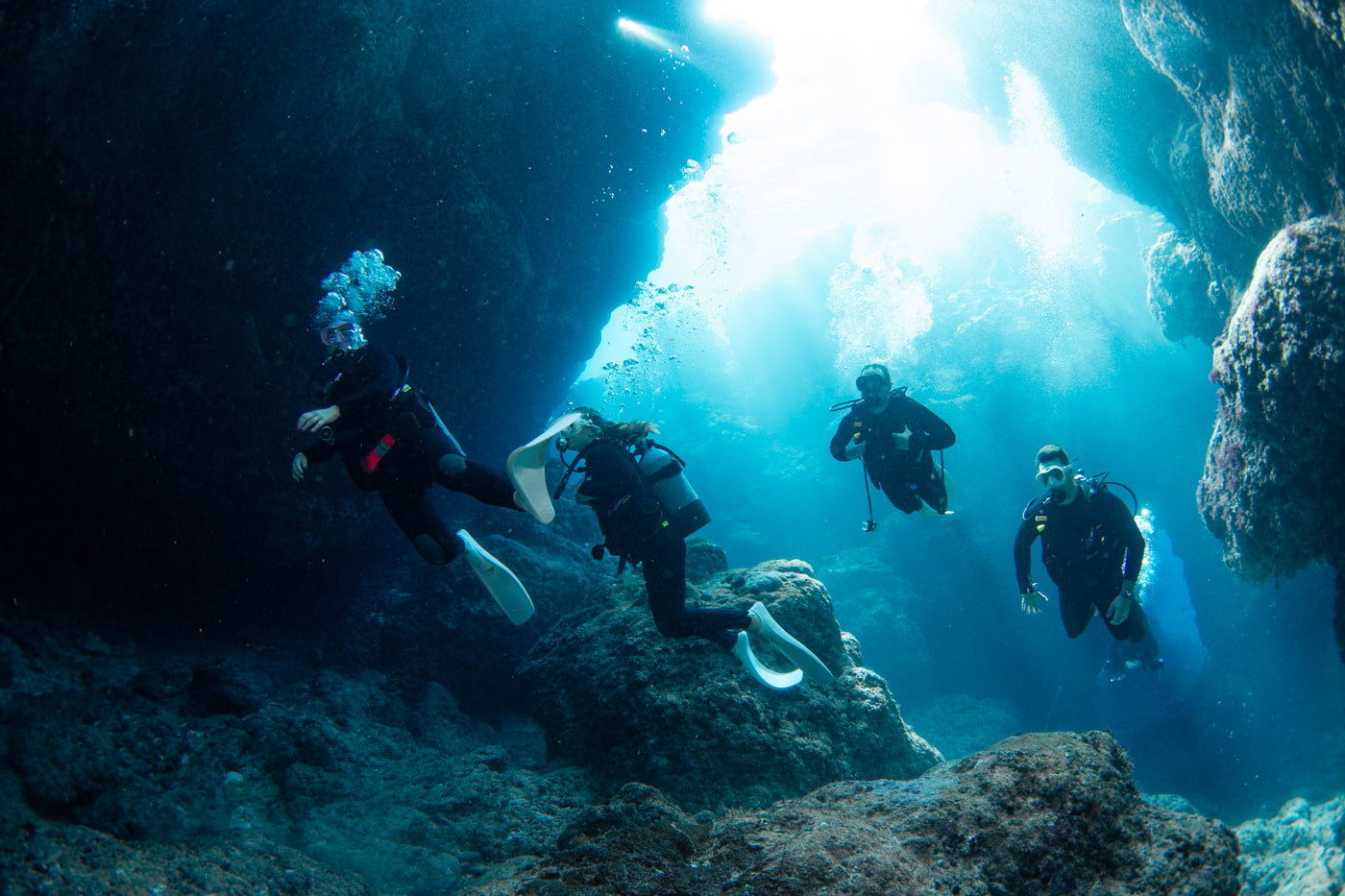 Guests diving inside a cave.