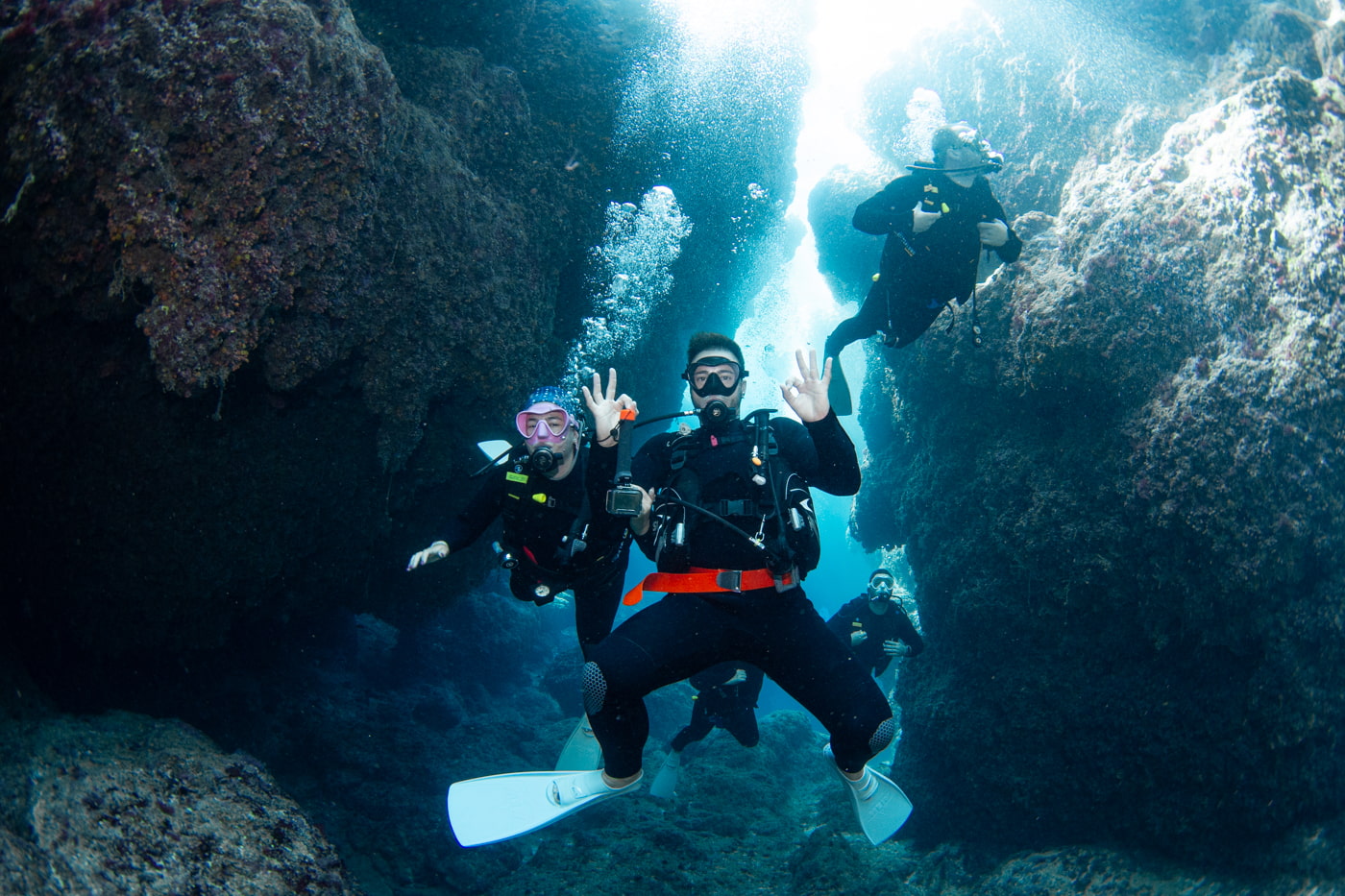 Guests diving inside a cave.