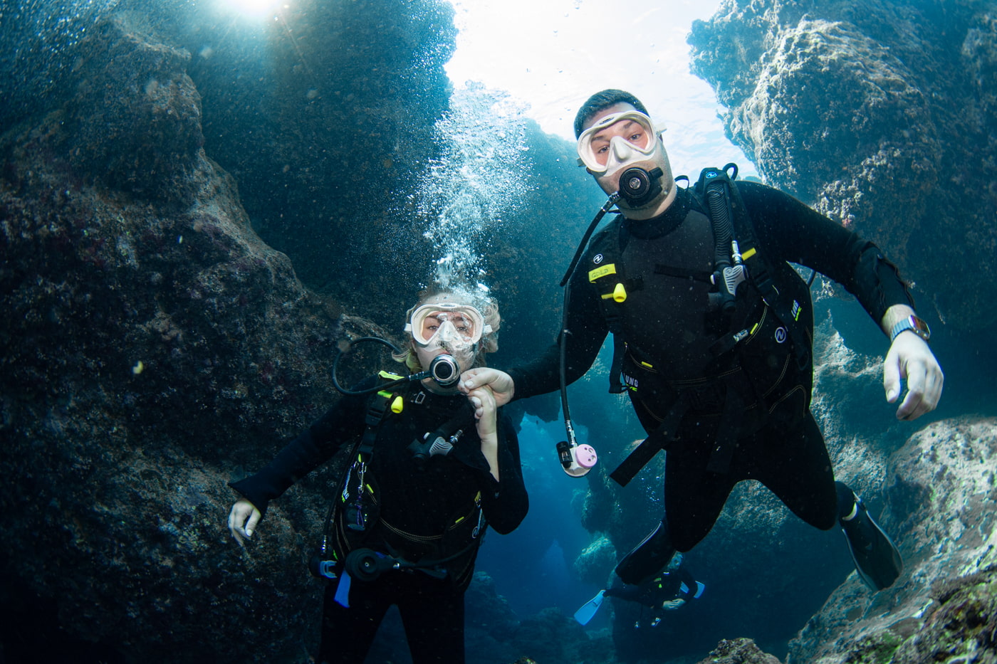 Guests diving inside a cave.