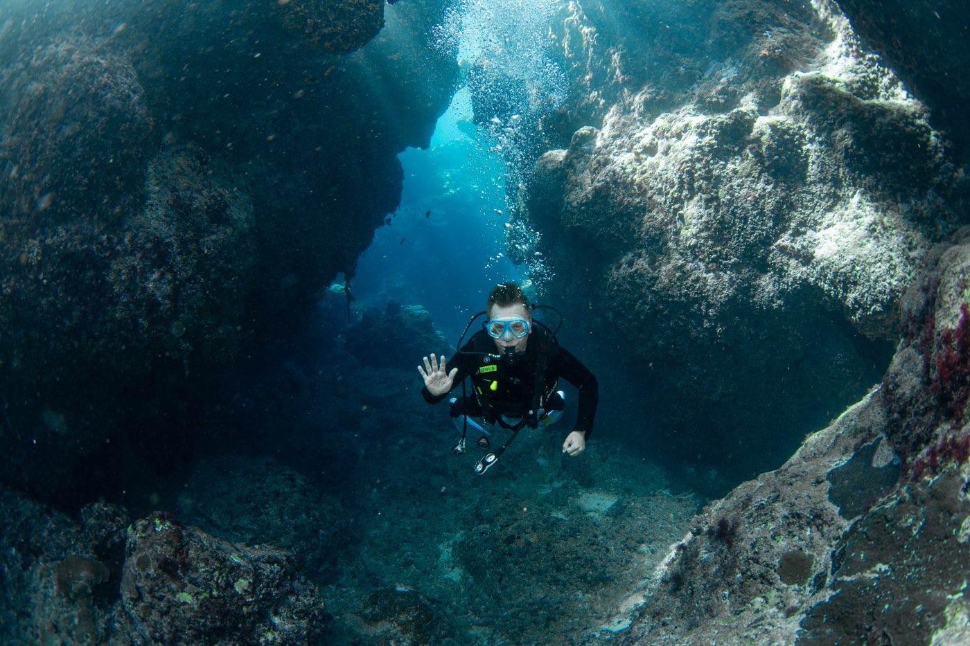 Guests diving inside a cave.