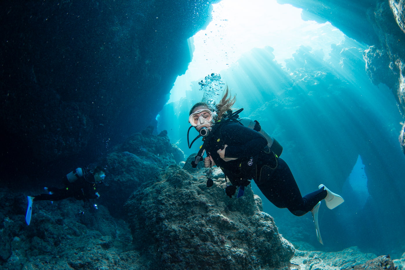 Guests diving inside a cave.