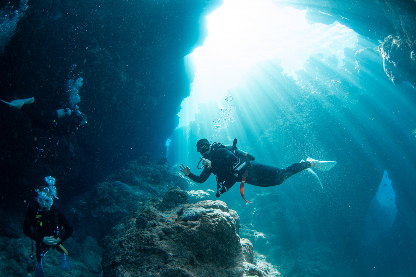 Guests diving inside a cave.