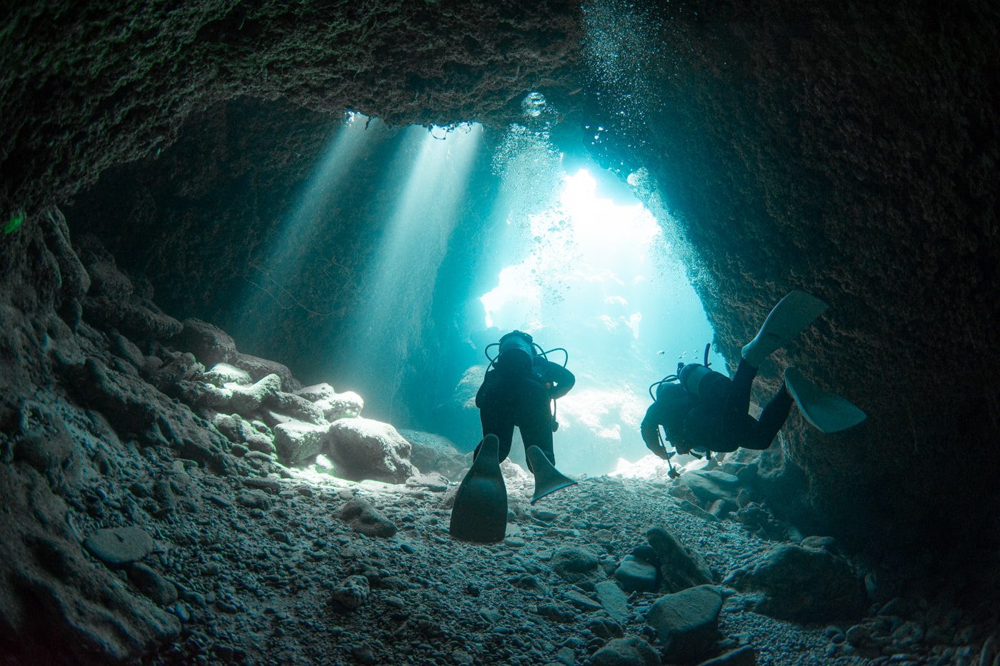 Guests diving inside a cave.