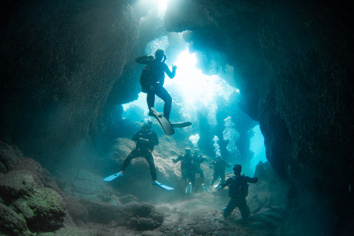 Guests diving inside a cave.