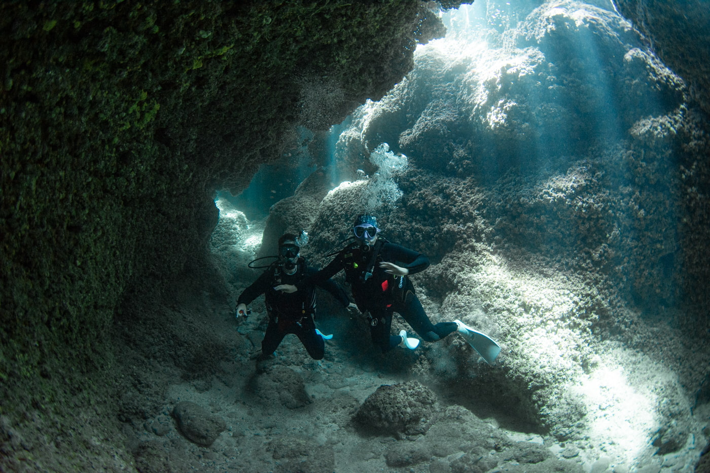 Guests diving inside a cave.