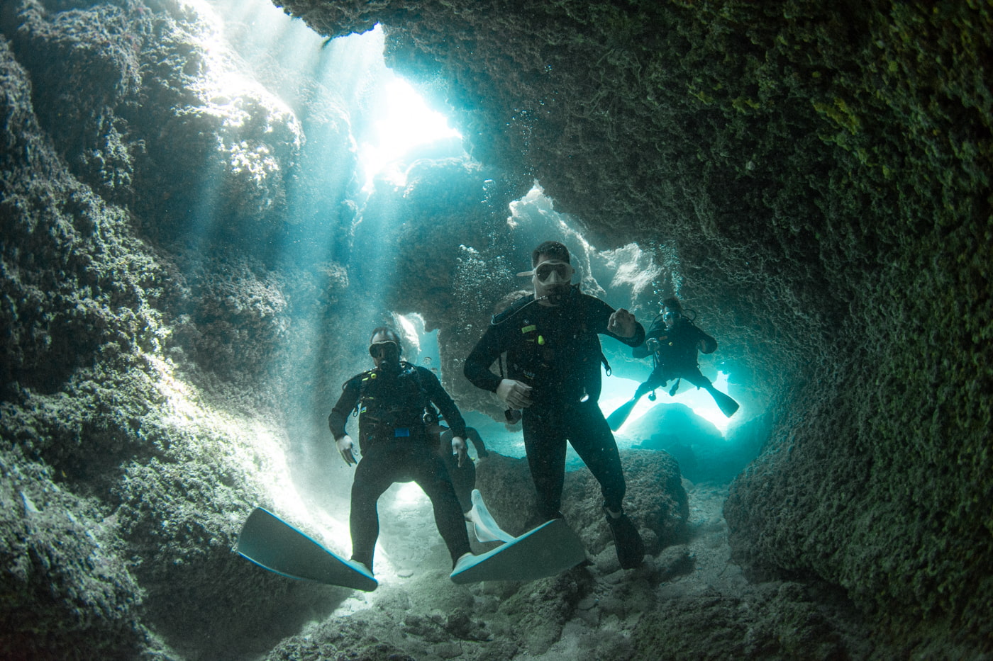 Guests diving inside a cave.