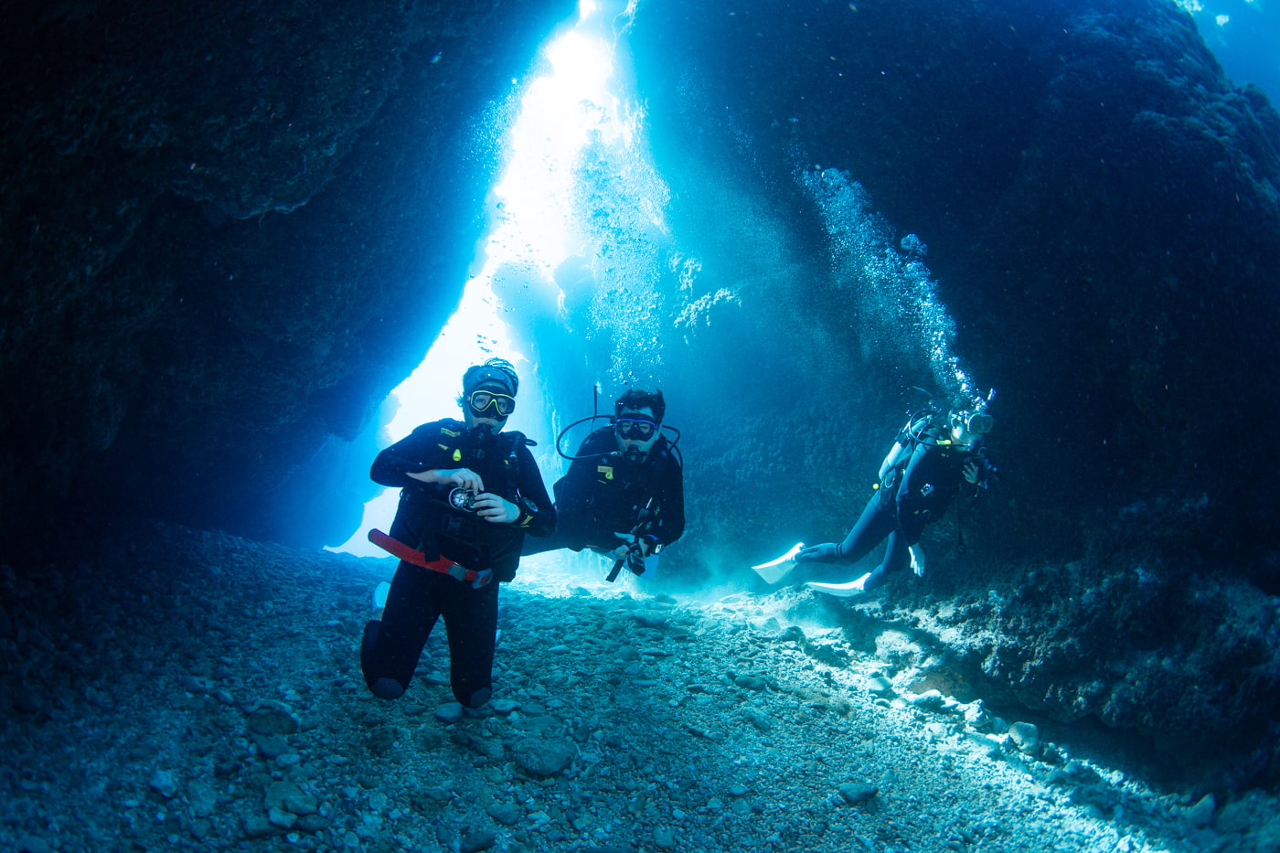 Guests diving inside a cave.