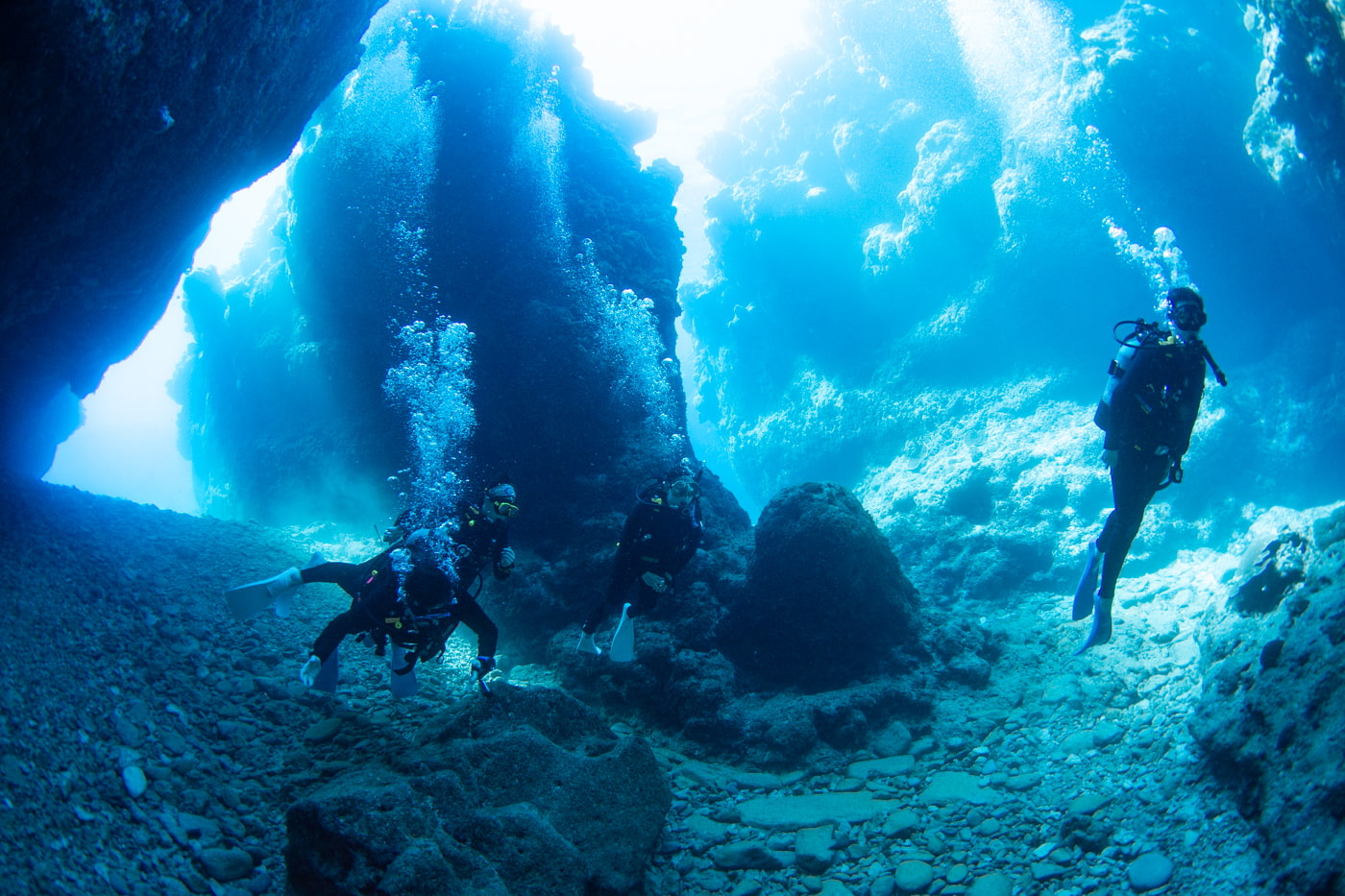 Guests diving inside a cave.