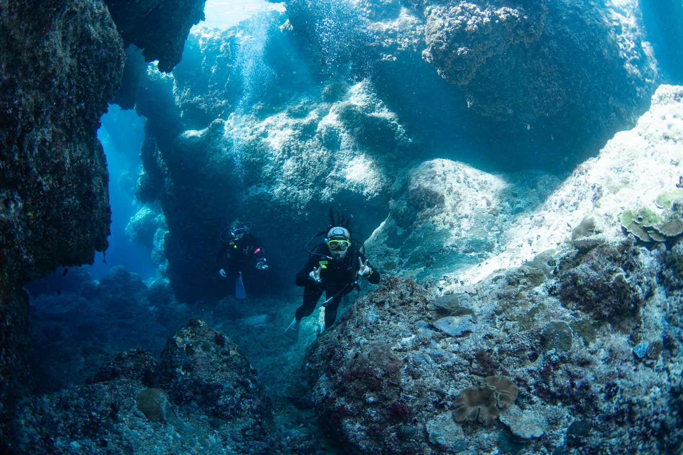 Guests diving inside a cave.