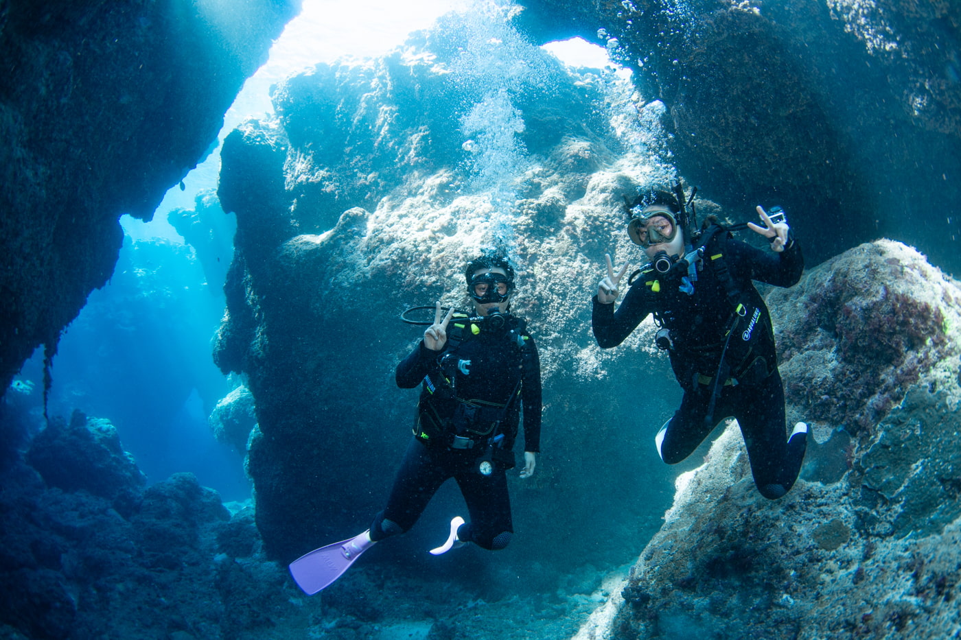 Guests diving inside a cave.
