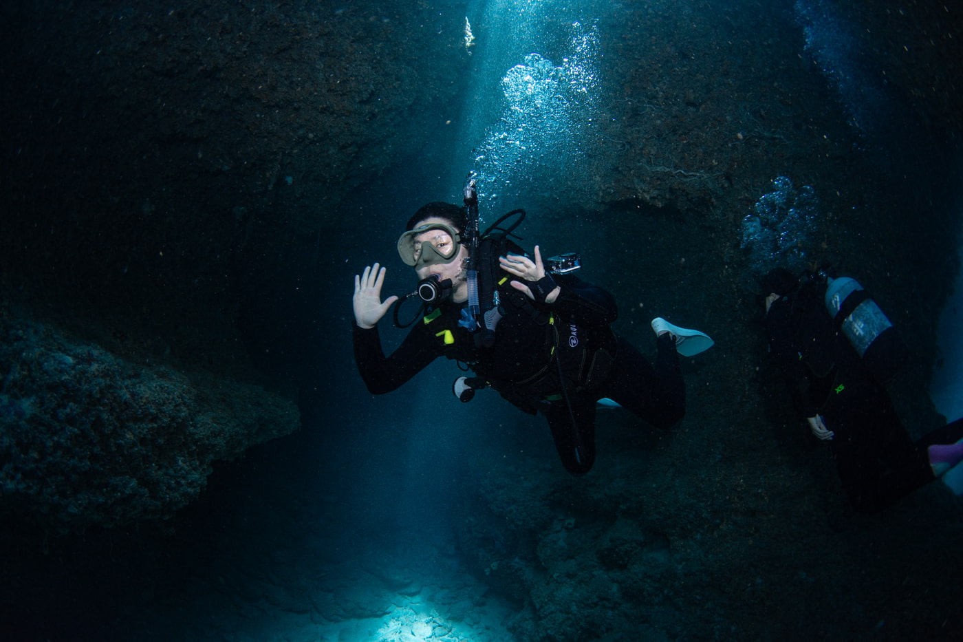Guests diving inside a cave.
