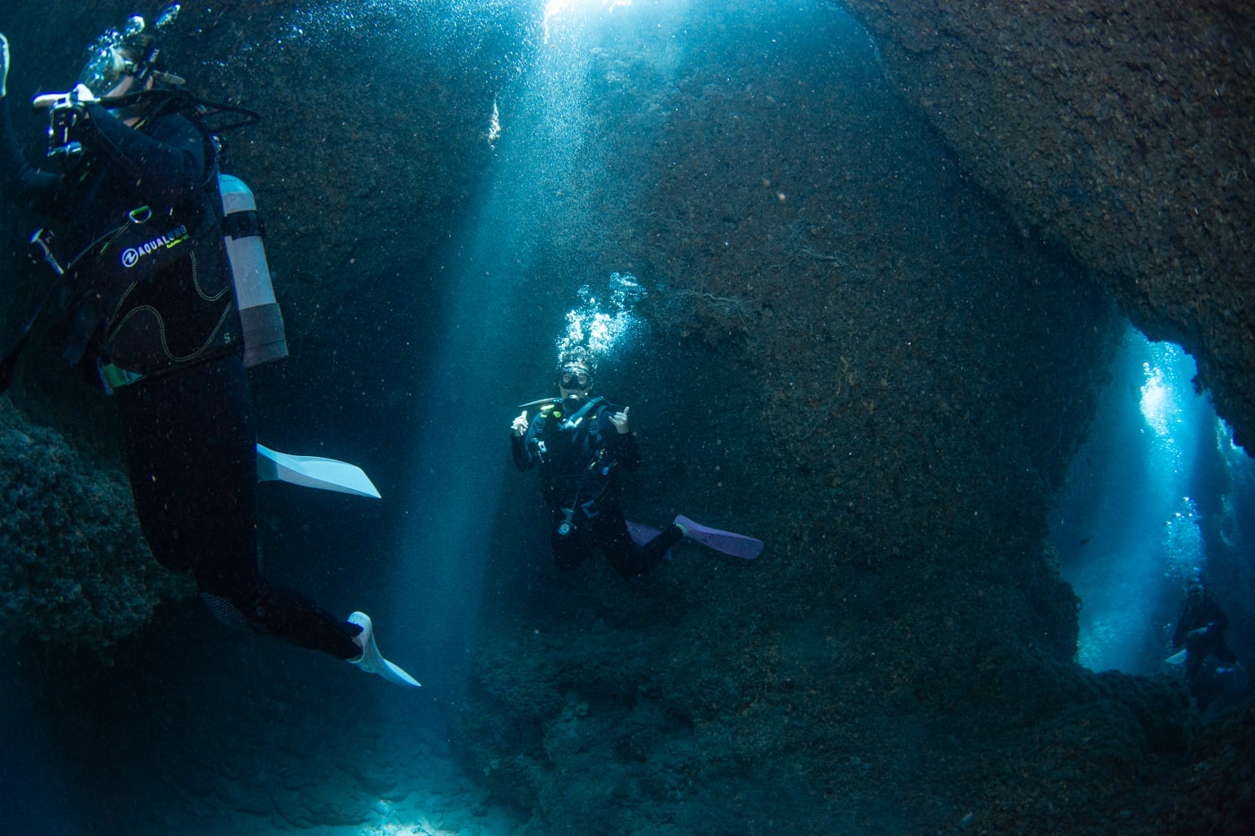 Guests diving inside a cave.