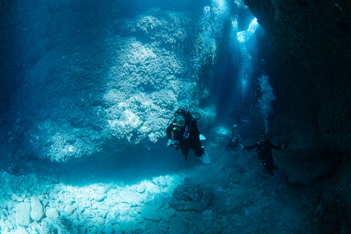 Guests diving inside a cave.