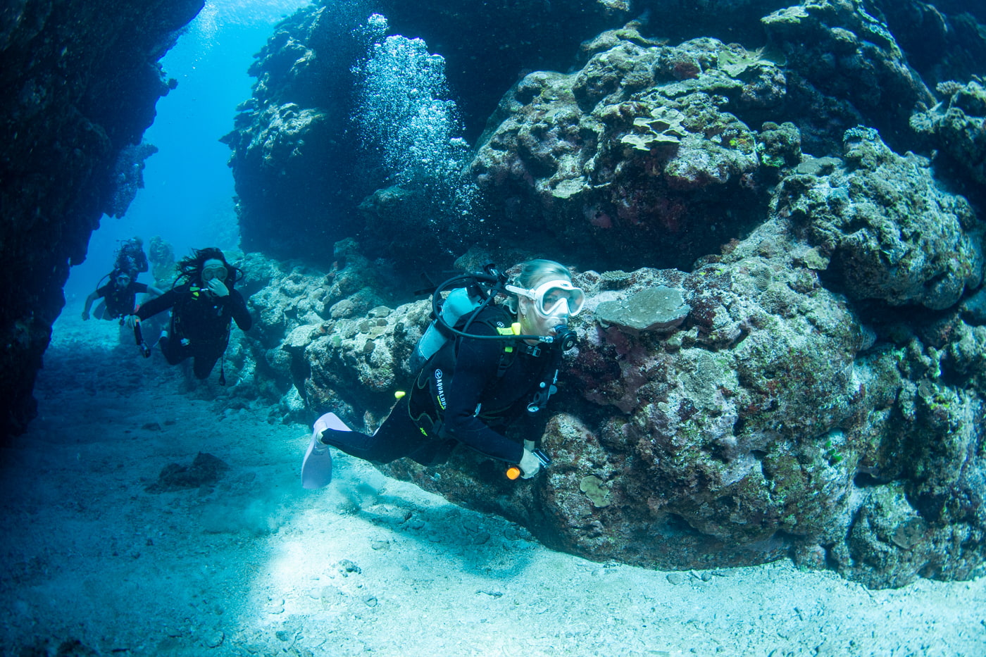 Guests diving inside a cave.