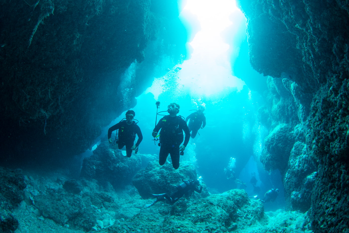 Guests diving inside a cave.