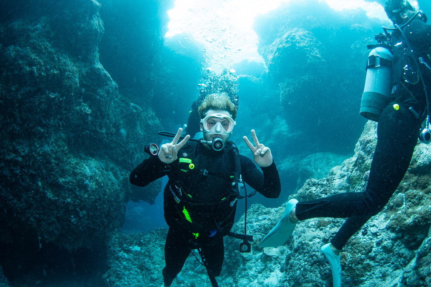 Guests diving inside a cave.