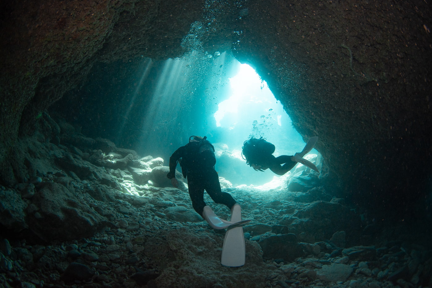 Guests diving inside a cave.