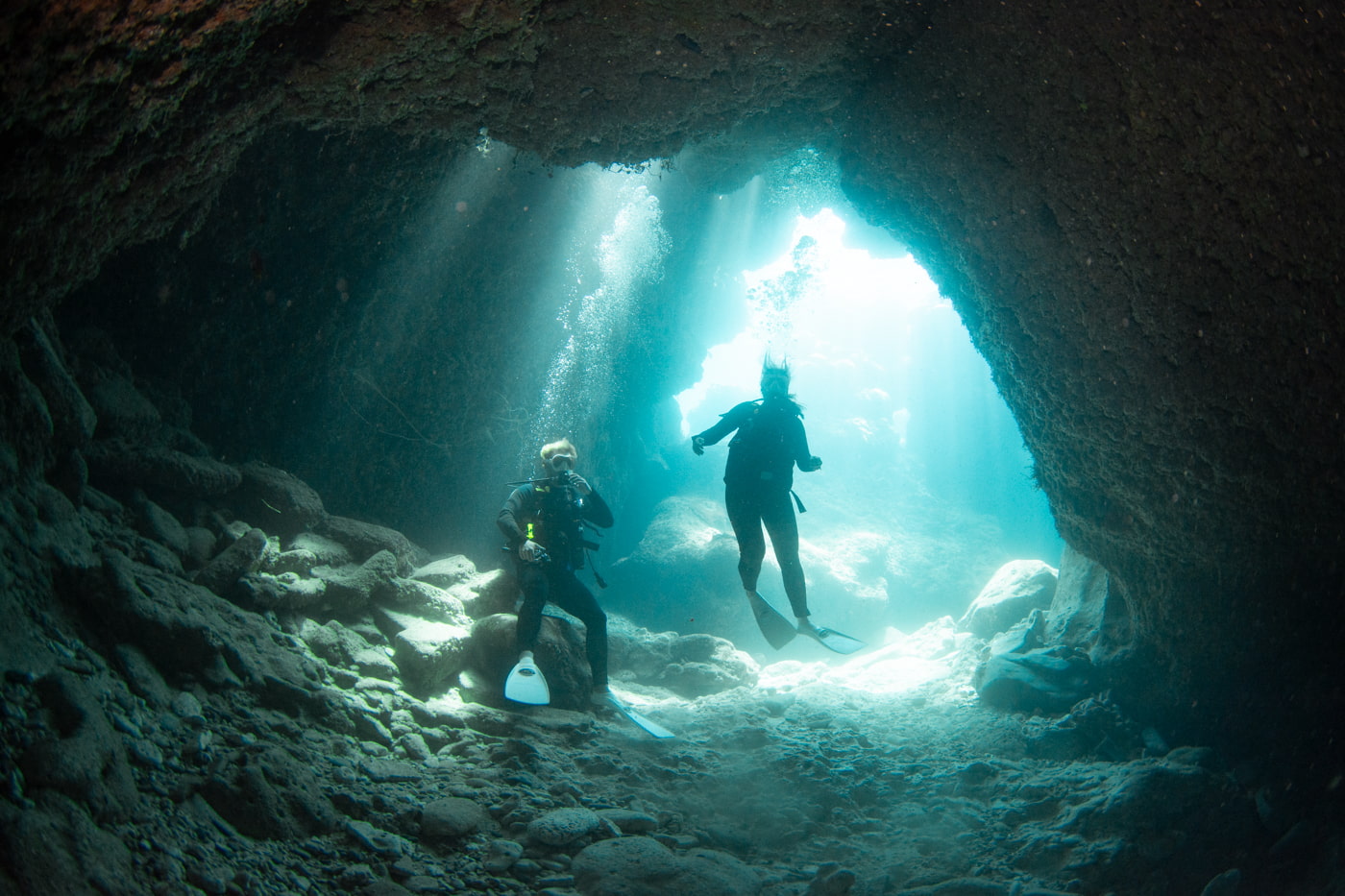 Guests diving inside a cave.