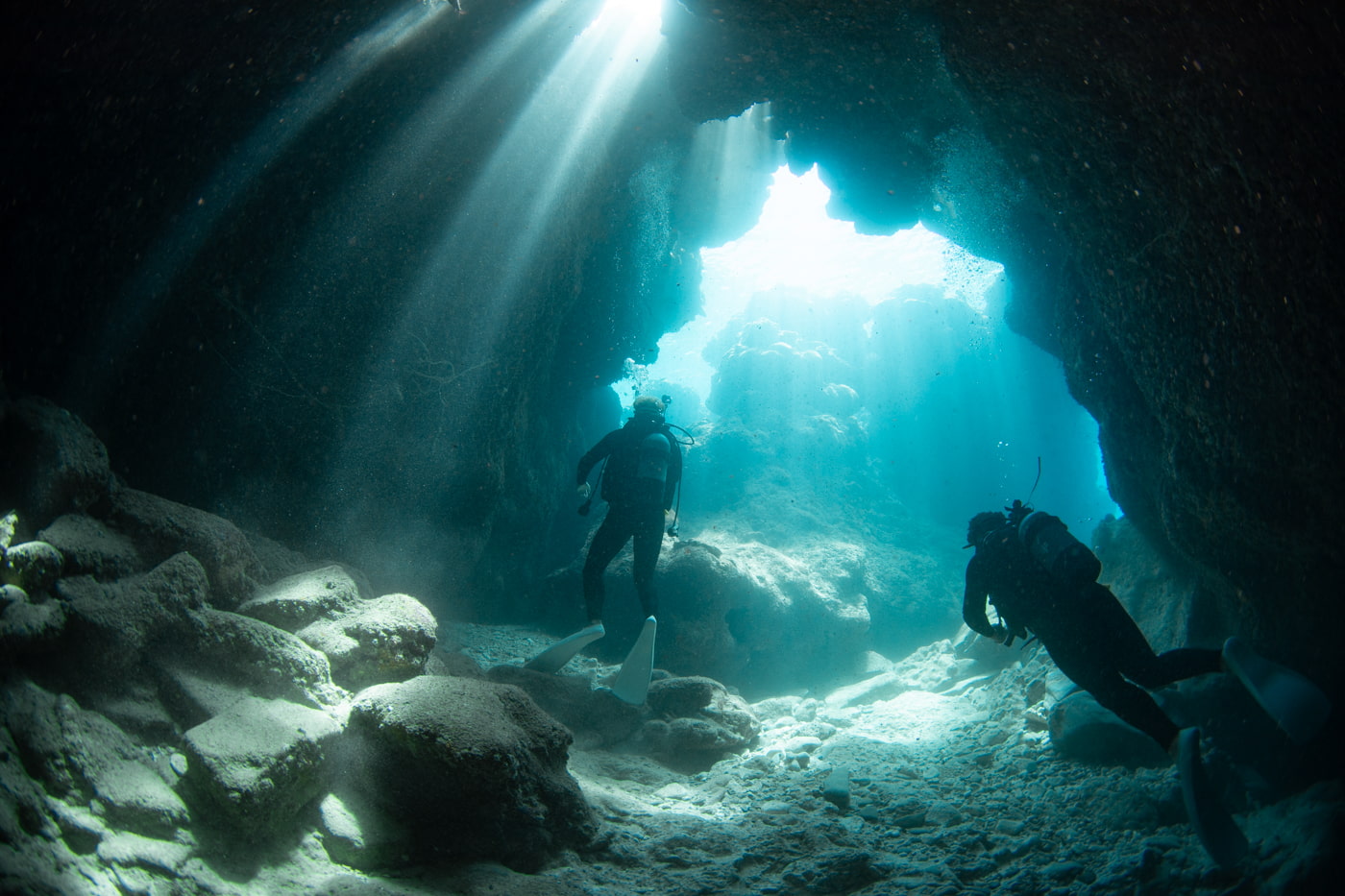 Guests diving inside a cave.