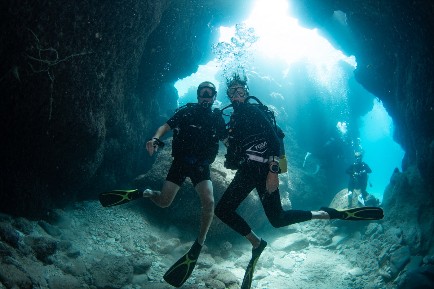 Guests diving inside a cave.
