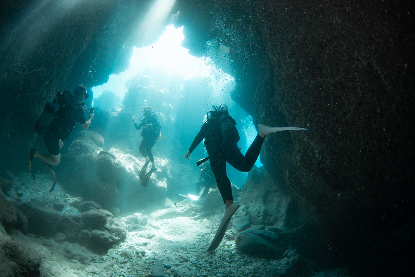 Guests diving inside a cave.