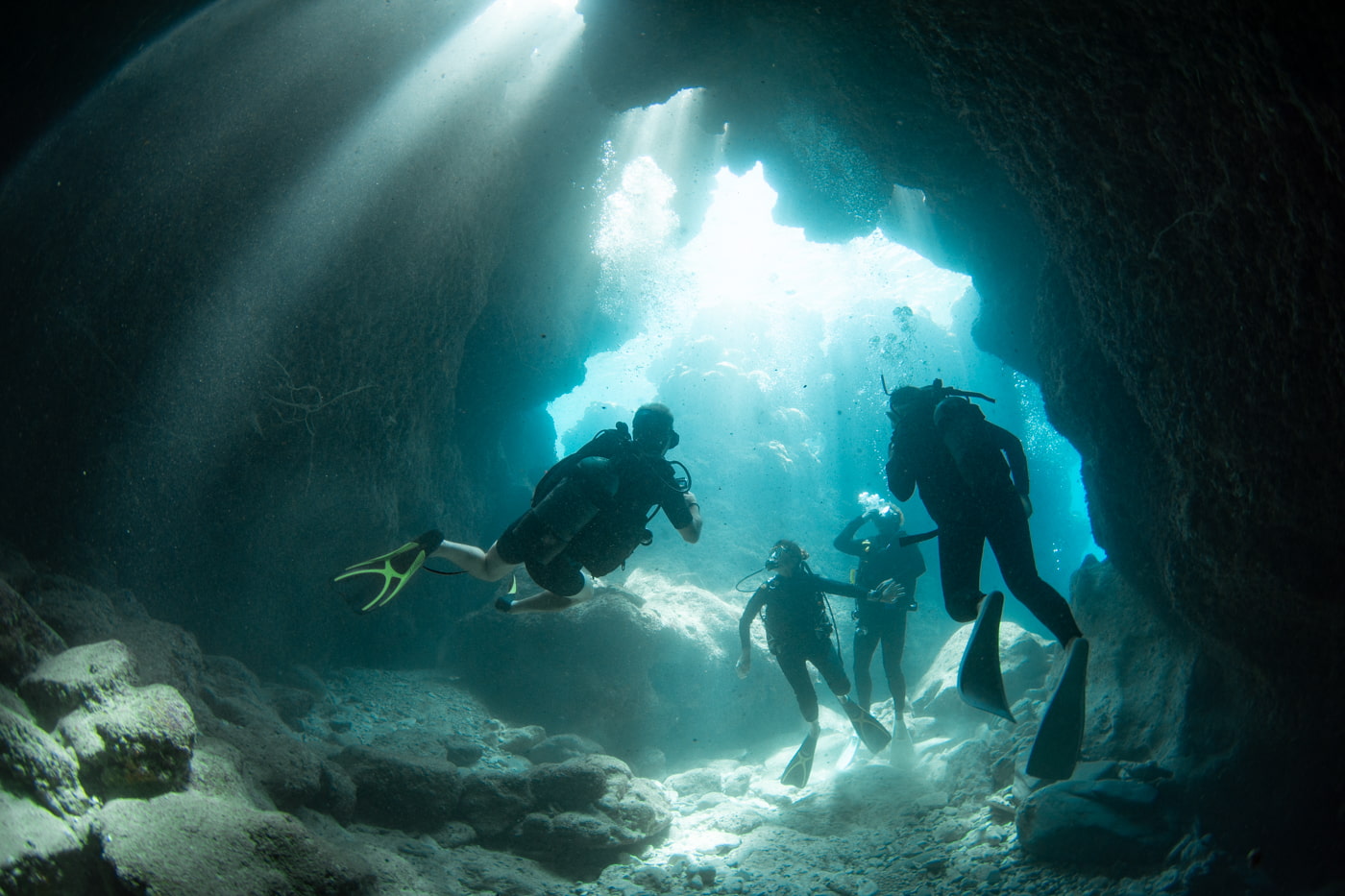 Guests diving inside a cave.