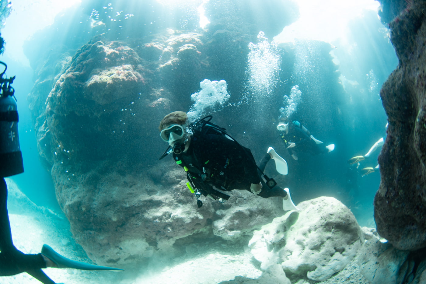 Guests diving inside a cave.