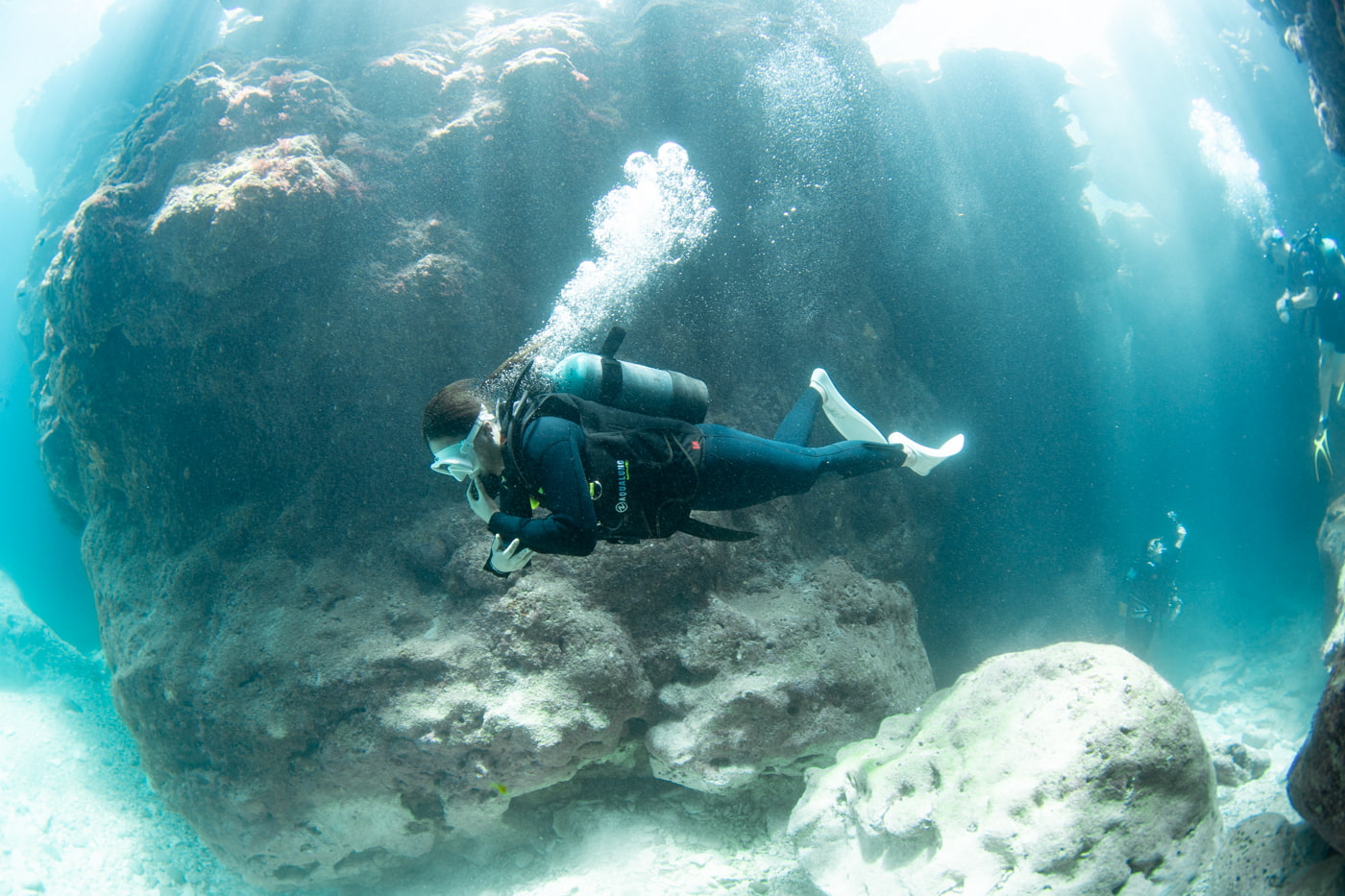 Guests diving inside a cave.
