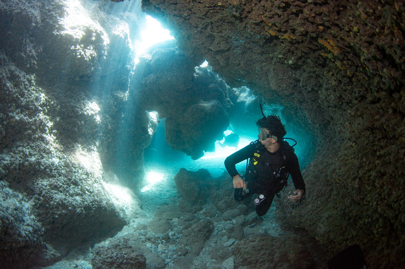 Guests diving inside a cave.