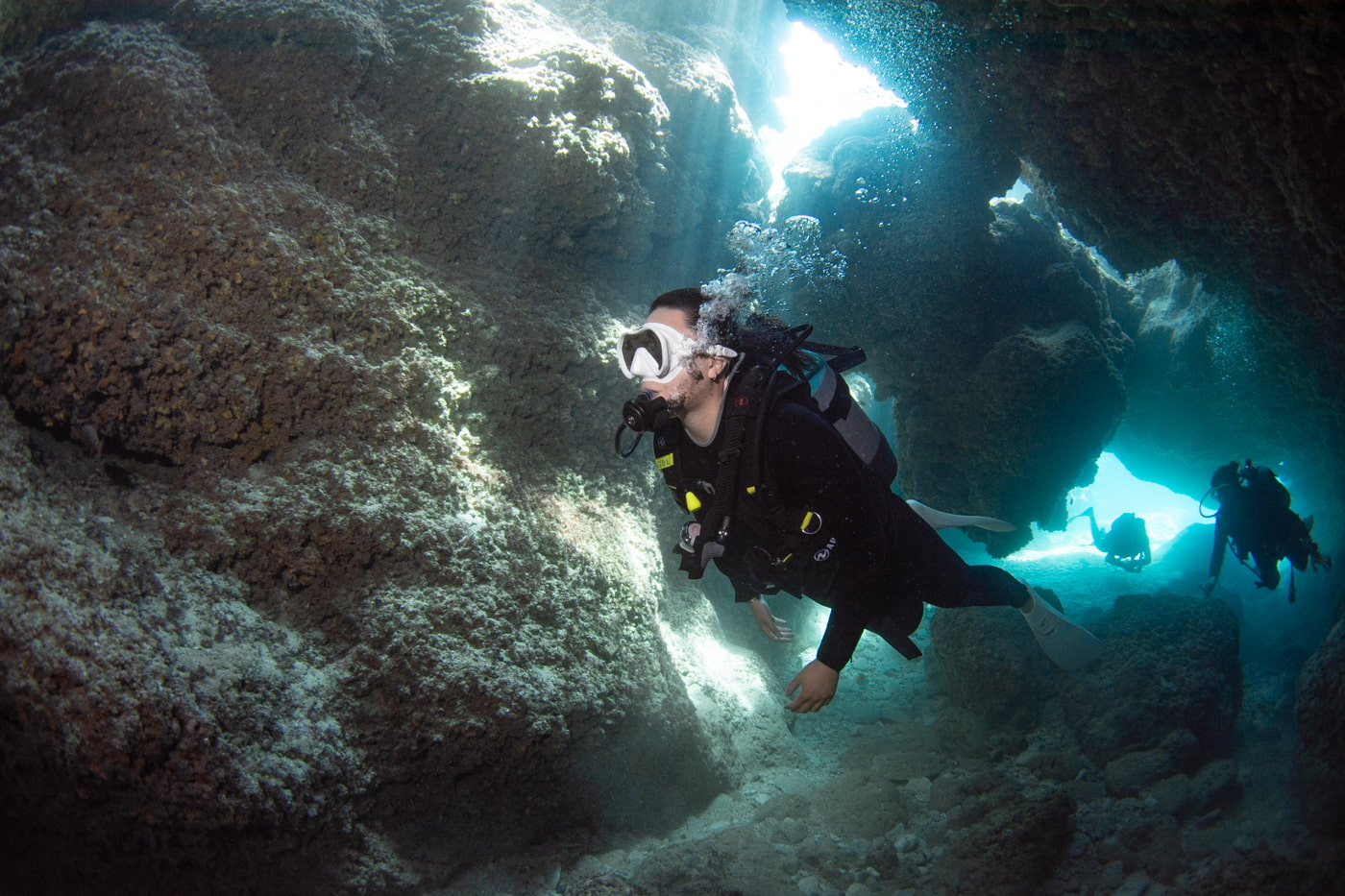 Guests diving inside a cave.