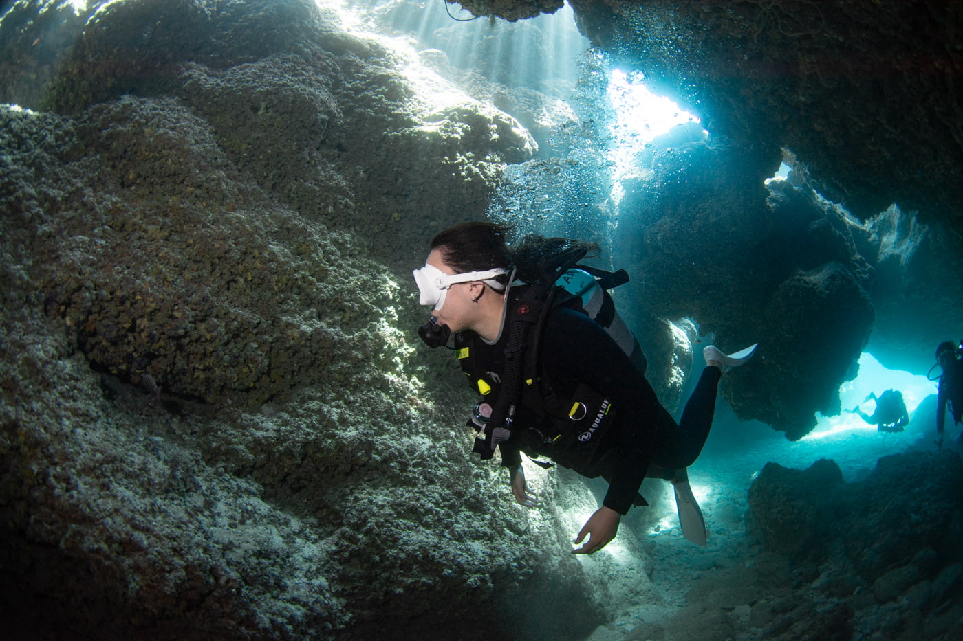 Guests diving inside a cave.