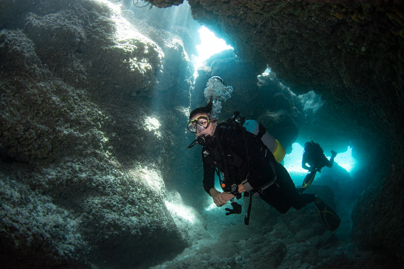 Guests diving inside a cave.
