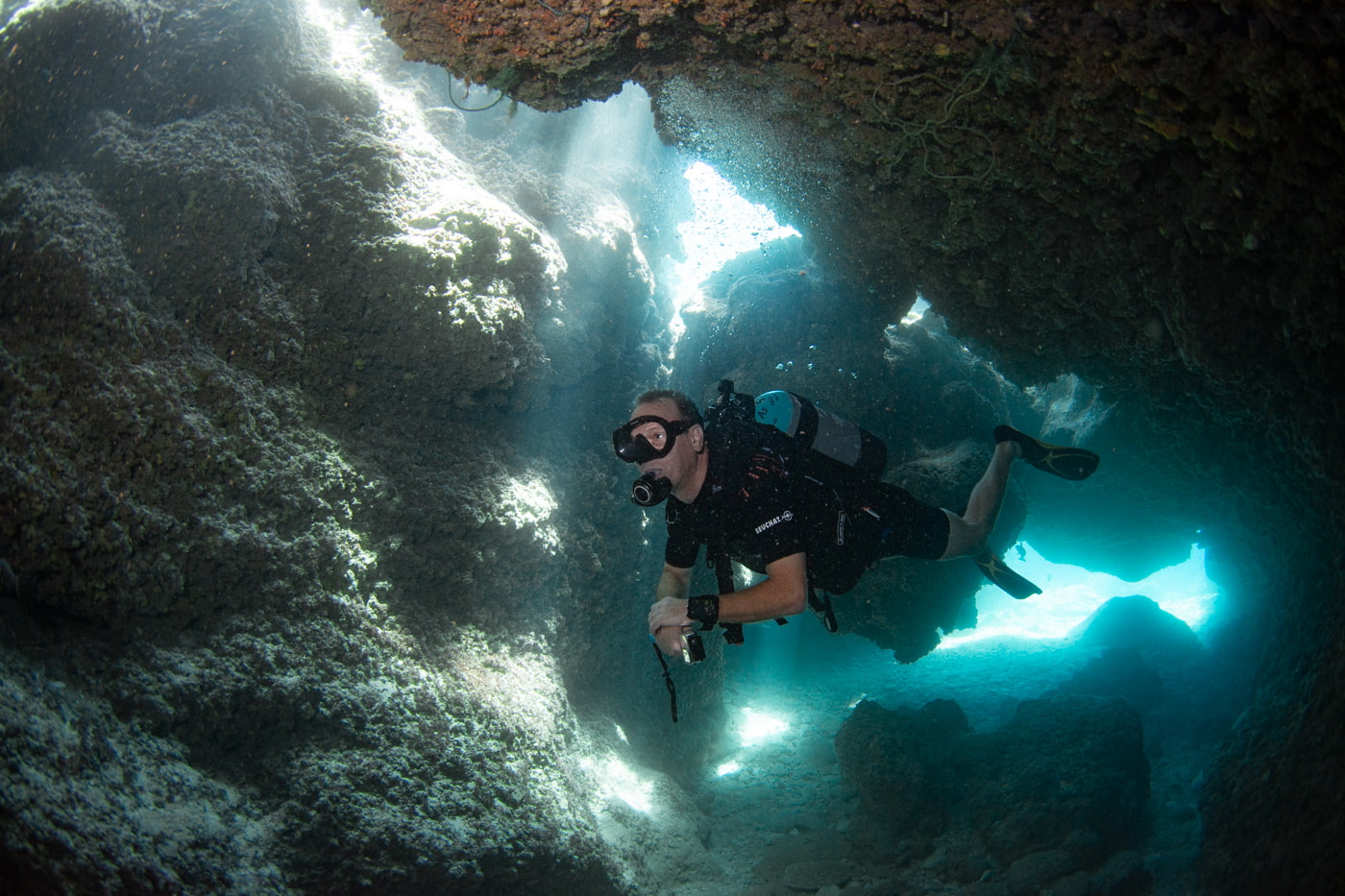 Guests diving inside a cave.