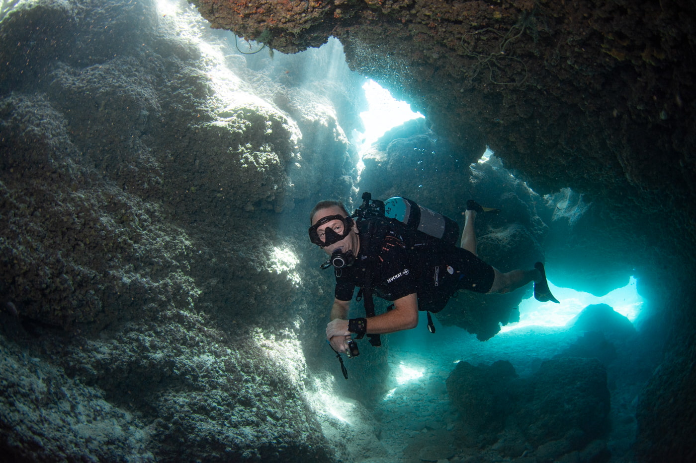 Guests diving inside a cave.