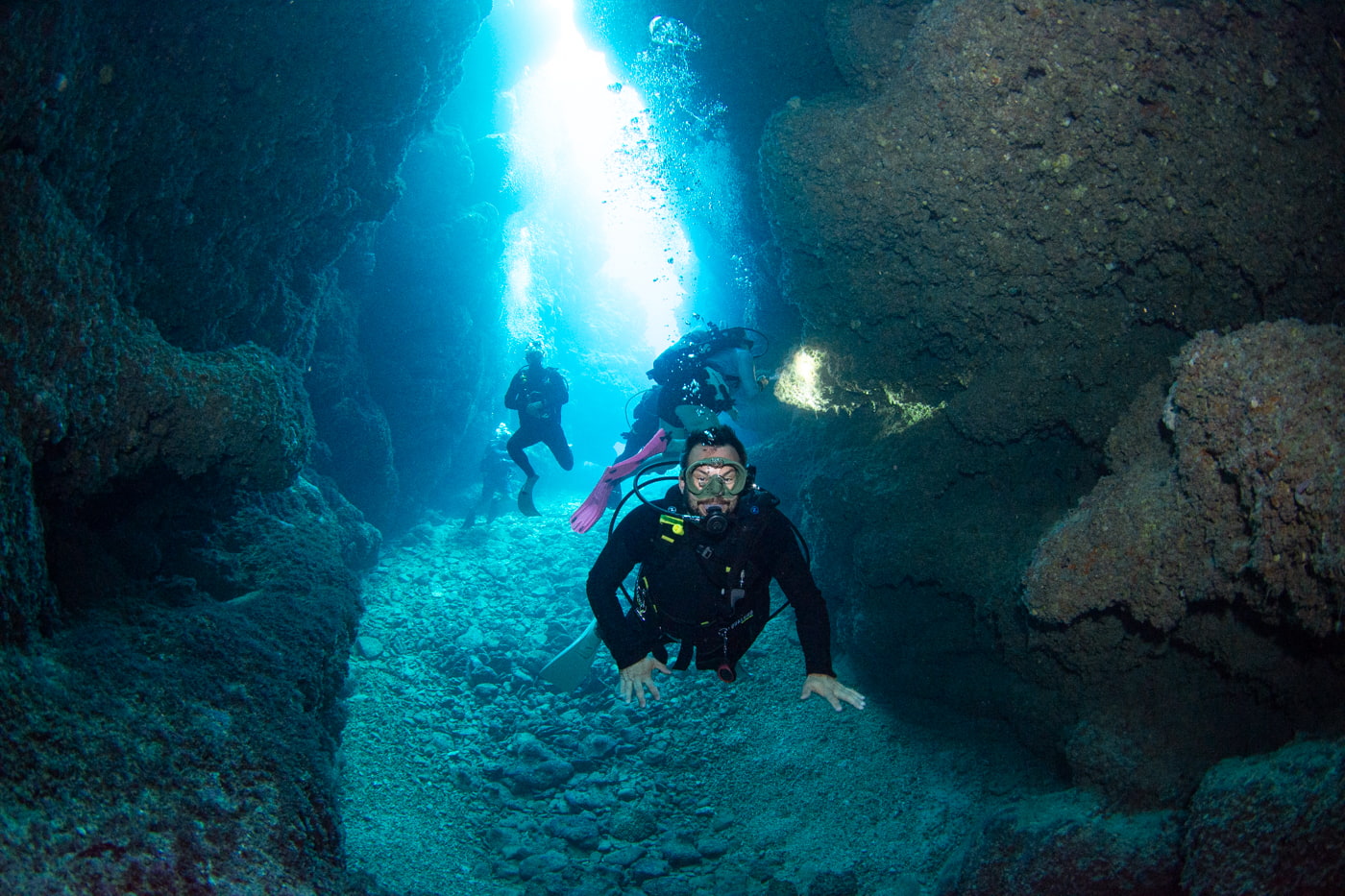 Guests diving inside a cave.