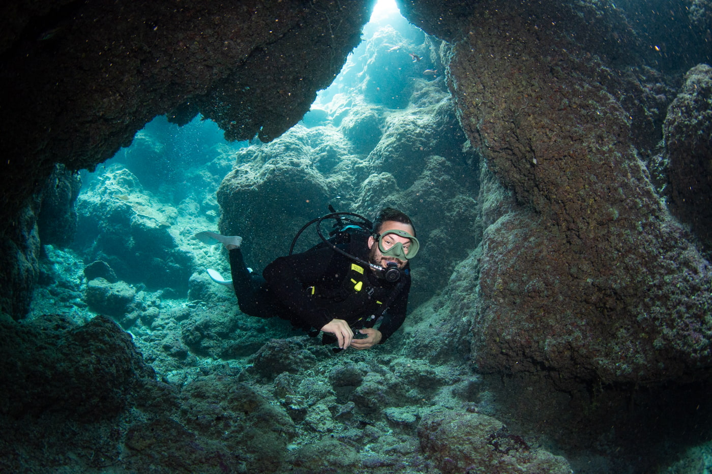Guests diving inside a cave.
