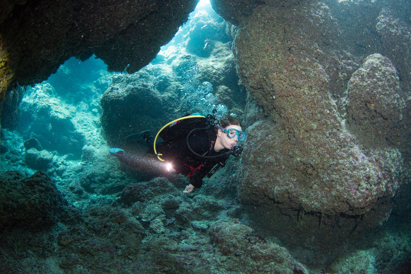 Guests diving inside a cave.